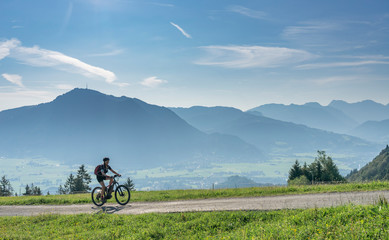 nice, active senior woman underway with her electric mountain bike in the Allgaeu Alps near Oberstdorf, Bavarian Alps, Germany