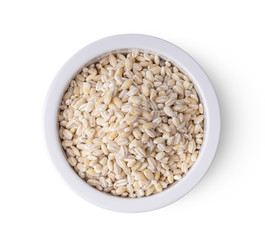 Heap of pearl barley in a bowl isolated on white background. top view