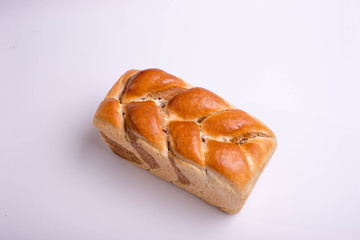 White bread baked from above in the form of a pigtail. Baking on a white background