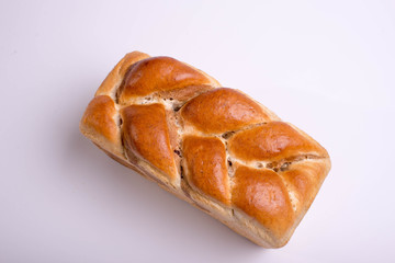 White bread baked from above in the form of a pigtail. Baking on a white background