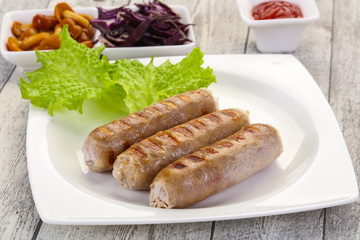 Grilled sausages served mushrooms and cabbage