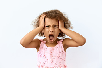 Frustrated and stress emotion. Portrait of Little African American girl against white background