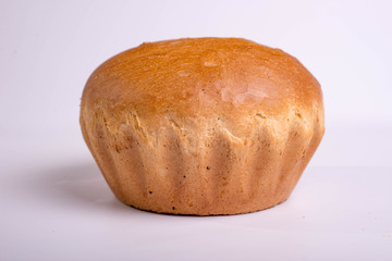 Beautiful white bread on a white background. Round baking