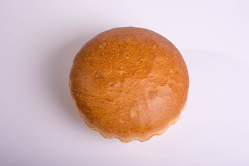 Beautiful white bread on a white background. Round baking