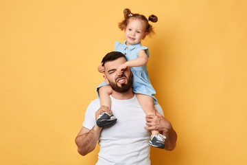 naughty girl holding her daddy's nose, display negative, angry behaviour. close up photo. isolated...