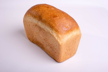 Baked loaf of bread on a white background. White square bread