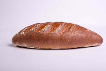 Wholegrain brown bread on a white background. Proper breakfast food