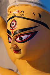 Idol of Hindu Goddess Durga during preparations in Kolkata. Clay idol of Goddess Durga, under...