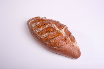 Wholegrain brown bread on a white background. Proper breakfast food