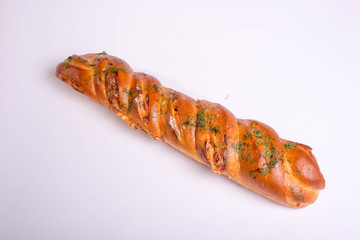 Baked baguette with herbs on white background