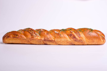 Baked baguette with herbs on white background