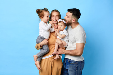 Happy family eating lollipop while standing over blue background. studio shot. close up portrait. happiness, love,strong relationship - 280889809
