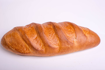 Baked long loaf on white background