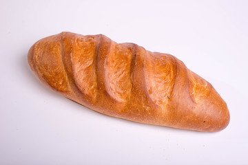 Baked long loaf on white background