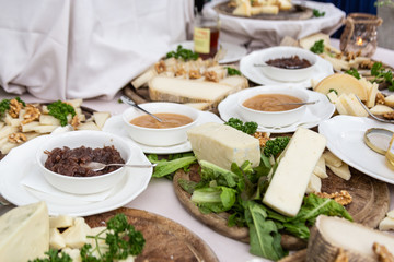 banquet of Italian cheeses on white table