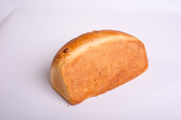 A loaf of bread on a white background. Baked delicious bread isolated