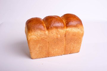 A loaf of bread on a white background. Baked delicious bread isolated