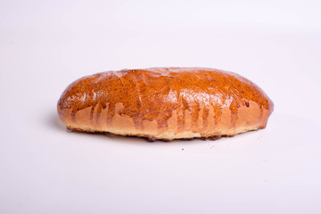 Bun with jam. Golden dessert pastry on a white background.