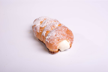 dessert in the form of tubes with cream. Buns covered with coconut flakes