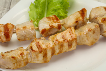 Grilled pork skewer served salad