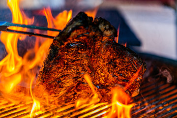 Grilling steaks on flaming grill.Beef steaks on grill.Grilling steak on BBQ