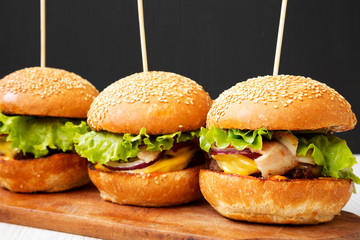 Homemade cheeseburgers and glass of cold beer, side view. Close-up.