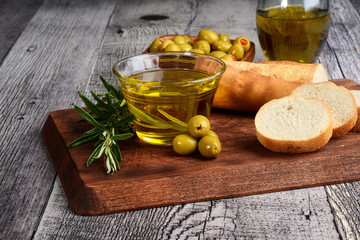 closeup green olives with oil and fresh bread