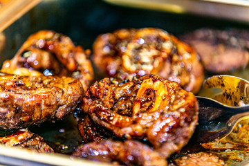Closeup of a fresh roasted meat on flaming grill.
