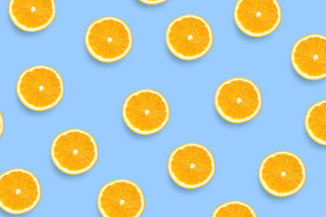 Fototapeta na wymiar Colorful fruit pattern of fresh orange slices on colored background. Orange slices top view.
