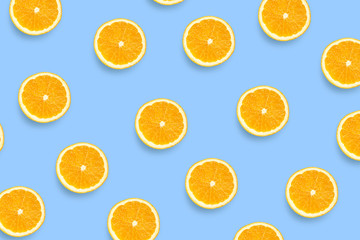 Colorful fruit pattern of fresh orange slices on colored background. Orange slices top view.