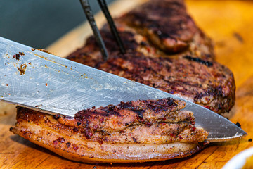 The chef prepares delicious roasted meat. Closeup of a fresh roasted meat