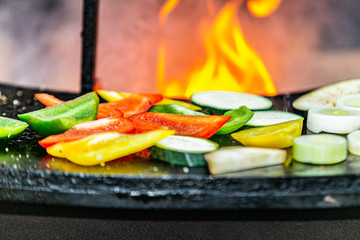 Closeup of a fresh color vegetable on flaming grill.