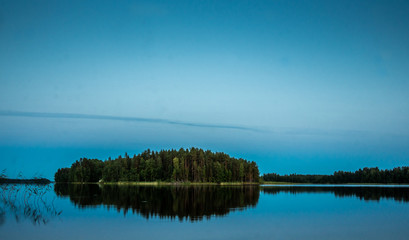 Sunset on the shores of the calm Saimaa lake in the Linnansaari National Park in Finland - 9