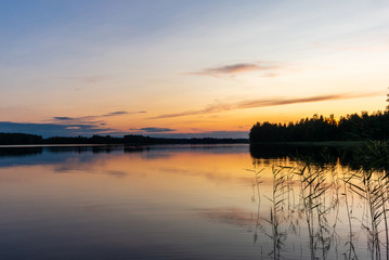 Reflections on the calm waters of the Saimaa lake in Finland at Sunset  - 2
