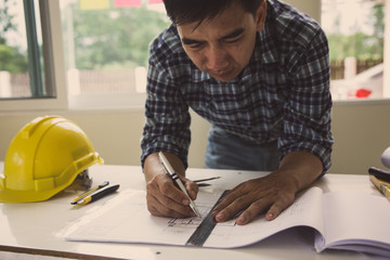 architect man handwriting with blueprint to build houses. After agreeing the employment price the...