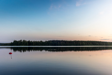 Reflections on the calm waters of the Saimaa lake in Finland at Sunset  - 4