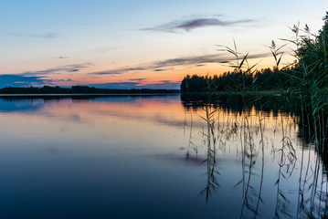Fototapeta na wymiar Reflections on the calm waters of the Saimaa lake in Finland at Sunset - 9