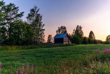 Traditional red nordic wooden shed in Finland during a colorful sunset - 4