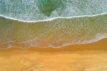 Fototapeta na wymiar Aerial view of ocean waves on a sandy beach, southern Africa.