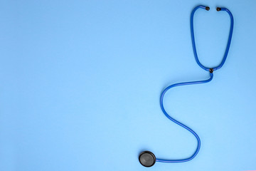 Global healthcare concept.Close-up of stethoscope on a blue background. Listen to the heart with stethoscope. Copy space for text . Flat lay