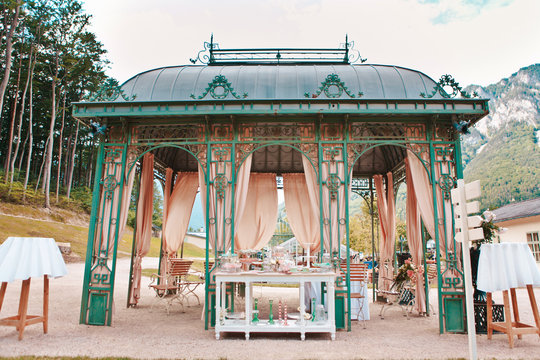 Picnic table with dishes, wine glasses, candleholders and various snacks, swomens day, wedding, celebration, romance, picnic, nature concept