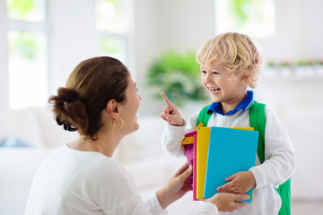 Child going back to school. Mother and kid.