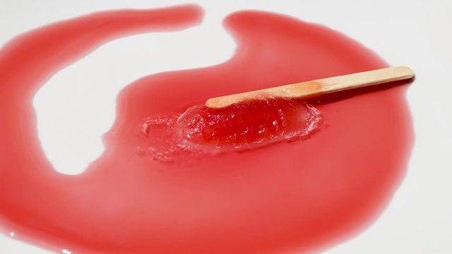 Red popsicle melting reverse time lapse