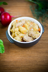 stewed potatoes with vegetables, cabbage and meat in a bowl