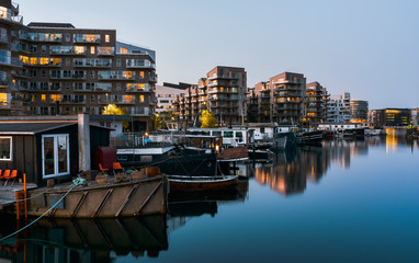 Beautiful panorama of houses on boats in water channel of Copenhagen on sunset - obrazy, fototapety, plakaty