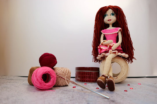  Sitting on the ball of yarn beautiful knitted crochette doll with the purse closeup