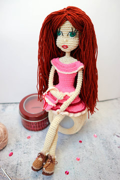 Sitting on the ball of yarn knitted crochette doll with the purse closeup