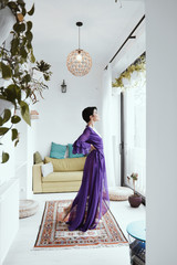 female with short haircut poses in Tbilisi loft