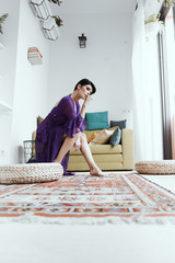 female with short haircut poses in Tbilisi loft