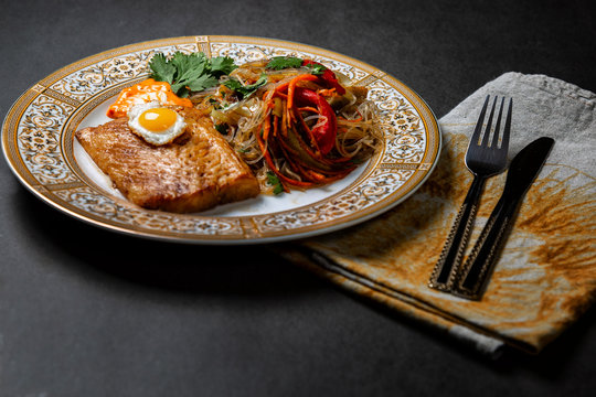 Grilled Halibut Steak With Vegetables - Sweet Peppers, Carrots, Cilantro, On A Dark Background